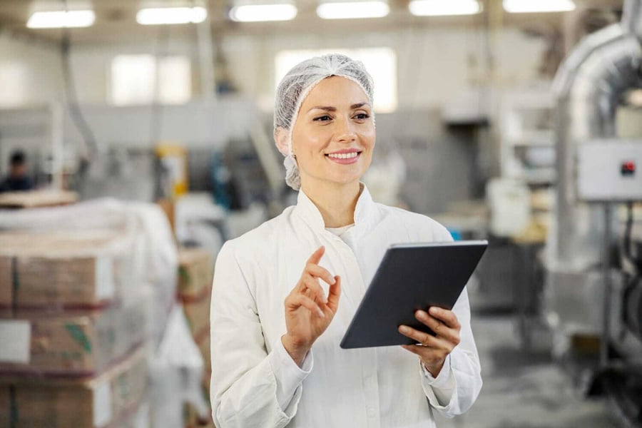 An operator with a tablet in a food factory
