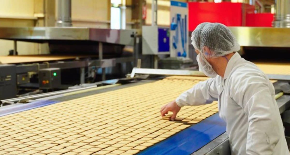 An operator at Pally Biscuits with a tablet