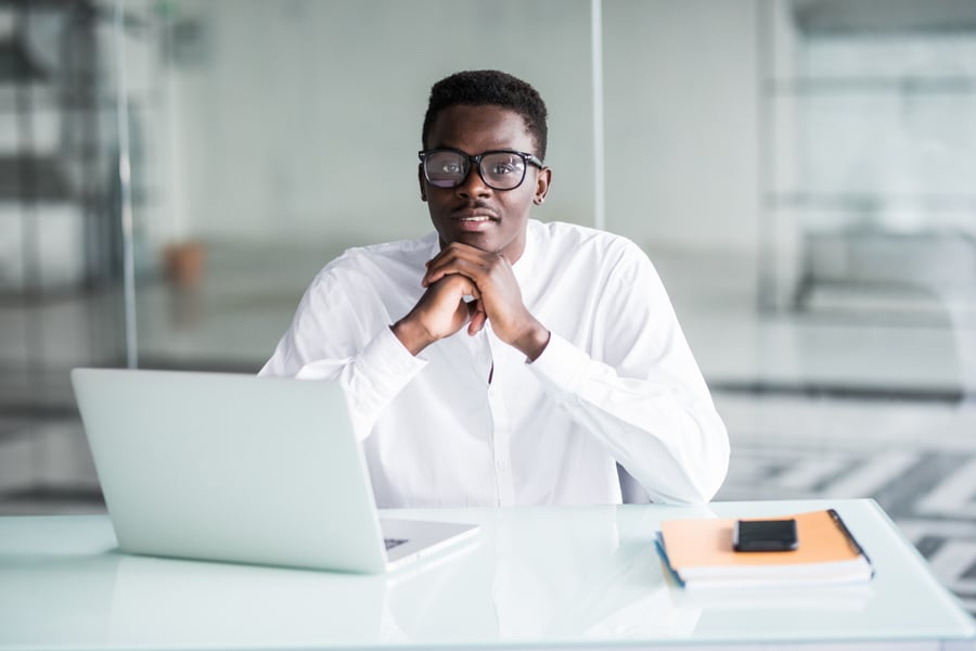 A colleague at a desk with a laptop